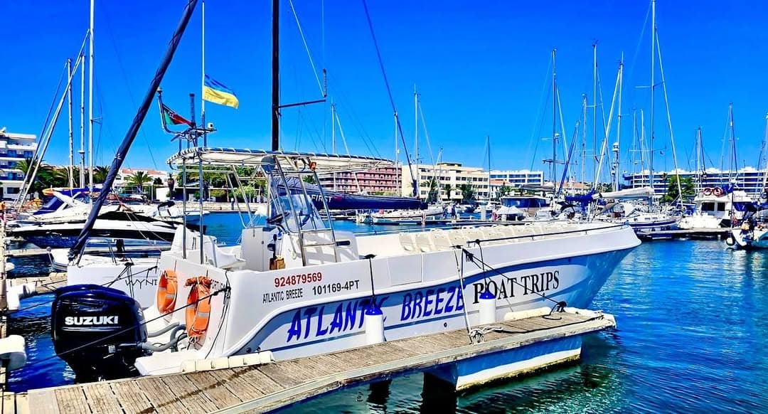 Atlantic Breeze — our tour boat at Marina de Lagos, Lugar 31 Atlantic Breeze tour boat with ATLANTIC BREEZE BOAT TRIPS branding moored at Marina de Lagos